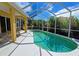 Relaxing kidney-shaped pool with a screened enclosure and patio furniture at 7596 Palmer Glen Cir, Sarasota, FL 34240