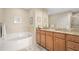 Elegant bathroom with double vanity, granite countertops, and large soaking tub at 808 3Rd W Ave # 210, Bradenton, FL 34205