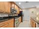 Sleek kitchen with stainless steel appliances and wood cabinets at 808 3Rd W Ave # 210, Bradenton, FL 34205