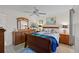 Bright bedroom with wooden sleigh bed and ceiling fan at 8142 Coco Solo Ave, North Port, FL 34287
