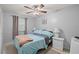 Light and airy bedroom with a ceiling fan and light blue bedding at 8142 Coco Solo Ave, North Port, FL 34287