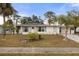 White single story home with palm trees and well manicured lawn at 8142 Coco Solo Ave, North Port, FL 34287