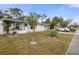 Side view of a white single story home with palm trees and a landscaped yard at 8142 Coco Solo Ave, North Port, FL 34287