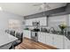 Bright kitchen with white cabinets, granite counters, and stainless steel appliances at 8142 Coco Solo Ave, North Port, FL 34287