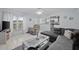 Living Room with grey sectional sofa, recliner and a view into kitchen at 8142 Coco Solo Ave, North Port, FL 34287