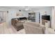Living room with grey sectional sofa, recliner, and access to backyard at 8142 Coco Solo Ave, North Port, FL 34287