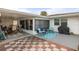 Checkered patio with seating area and grill at 8142 Coco Solo Ave, North Port, FL 34287