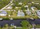 Aerial view of the property, highlighting its canal-front location and neighborhood at 9008 Allapata Ln, Venice, FL 34293