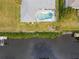 Aerial view showing home, pool, canal, and lush landscaping at 9008 Allapata Ln, Venice, FL 34293