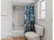 Bathroom with tub, toilet, and a tropical shower curtain at 9008 Allapata Ln, Venice, FL 34293