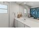 Bathroom with single vanity, a walk-in shower, and a window at 9008 Allapata Ln, Venice, FL 34293