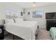 Bedroom with a queen bed, TV, and window with blinds at 9008 Allapata Ln, Venice, FL 34293
