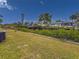 Peaceful canal-front view with lush landscaping and neighboring homes at 9008 Allapata Ln, Venice, FL 34293