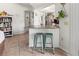 Kitchen with granite breakfast bar and teal stools at 9008 Allapata Ln, Venice, FL 34293
