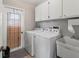Laundry room with washer, dryer, utility sink, and exterior access at 9008 Allapata Ln, Venice, FL 34293
