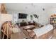 Living room with comfy brown couch and large flat-screen TV at 9008 Allapata Ln, Venice, FL 34293