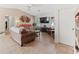Living room with brown couches, a coffee table, and a ceiling fan at 9008 Allapata Ln, Venice, FL 34293