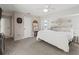 King-size bed in a well-lit main bedroom with calming decor at 9008 Allapata Ln, Venice, FL 34293
