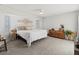 Spacious main bedroom with king-size bed, dresser, and ample natural light at 9008 Allapata Ln, Venice, FL 34293