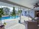 Cozy patio with wicker furniture overlooking the refreshing pool at 9008 Allapata Ln, Venice, FL 34293