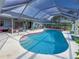 Spacious pool area with screened enclosure, comfortable seating and lush greenery at 9008 Allapata Ln, Venice, FL 34293
