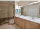 Bathroom boasts double sinks, a large mirror, and a shower at 9435 Discovery Ter # 202D, Bradenton, FL 34212