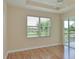 Bedroom features wood-look floors and a view at 9435 Discovery Ter # 202D, Bradenton, FL 34212