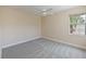 Simple bedroom with gray carpet and large window at 9435 Discovery Ter # 202D, Bradenton, FL 34212