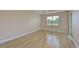 Bright bedroom with wood-look floors and sliding glass door at 9435 Discovery Ter # 202D, Bradenton, FL 34212
