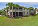 Building exterior with lush landscaping and palm trees at 9435 Discovery Ter # 202D, Bradenton, FL 34212