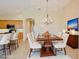 Elegant dining room with chandelier and virtually staged furniture at 9435 Discovery Ter # 202D, Bradenton, FL 34212