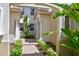 Inviting entryway with brick walkway and lush landscaping at 9435 Discovery Ter # 202D, Bradenton, FL 34212