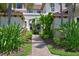 Well-manicured entryway with lush landscaping and brick walkways at 9435 Discovery Ter # 202D, Bradenton, FL 34212