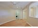 Bright hallway with hardwood floors and access to laundry at 9435 Discovery Ter # 202D, Bradenton, FL 34212