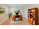 Bright home office features built-in shelving and hardwood floors at 9435 Discovery Ter # 202D, Bradenton, FL 34212