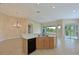 Open kitchen with island, stainless steel appliances, and wood cabinets at 9435 Discovery Ter # 202D, Bradenton, FL 34212