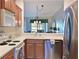 Well-equipped kitchen featuring stainless steel appliances and light wood cabinets at 1003 Fairwaycove Ln # 101, Bradenton, FL 34212