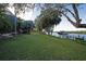 Grass backyard, stone pathway, and private dock at 10309 Riverbank Ter, Bradenton, FL 34212