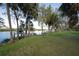 Landscaped backyard with a private dock and water access at 10309 Riverbank Ter, Bradenton, FL 34212