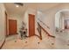 Elegant hallway with tile flooring and staircase at 10309 Riverbank Ter, Bradenton, FL 34212