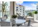 Private balcony with outdoor furniture and stunning water views at 111 Golden Gate Pt # 401, Sarasota, FL 34236