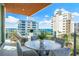 Spacious balcony with outdoor furniture and city views at 111 Golden Gate Pt # 401, Sarasota, FL 34236