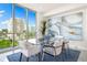 Bright dining room with glass table and city view at 111 Golden Gate Pt # 401, Sarasota, FL 34236