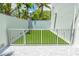 Private dog park with artificial turf and gated entrance at 111 Golden Gate Pt # 401, Sarasota, FL 34236