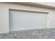 White garage door with gray paver driveway at 111 Golden Gate Pt # 401, Sarasota, FL 34236