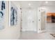 Elegant hallway with two doors and modern art at 111 Golden Gate Pt # 401, Sarasota, FL 34236