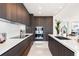 Modern kitchen with dark wood cabinets and appliances at 111 Golden Gate Pt # 401, Sarasota, FL 34236