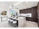 Modern kitchen with an island and white countertop at 111 Golden Gate Pt # 401, Sarasota, FL 34236