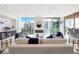 Living room with fireplace and stunning city views at 111 Golden Gate Pt # 401, Sarasota, FL 34236