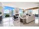 Bright living room with city views and fireplace at 111 Golden Gate Pt # 401, Sarasota, FL 34236